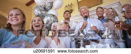 Stock Image - Family celebrating at party. Fotosearch