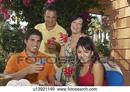 Family with drinks in garden View Large Photo Image Stock Photo - Family with drinks in garden. Fotosearch