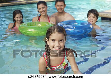 Family with two girls and boy with inflatable rafts, in swimming pool, portrait View Large Photo Image Picture - Family with two girls and boy with inflatable rafts, in swimming pool, portrait. Fotosearch
