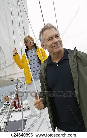 Father and adult son on yacht View Large Photo Image Stock Photograph - Father and adult son on yacht. Fotosearch
