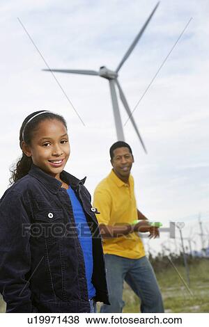 Father and daughter (7-9) playing with disc at wind farm View Large Photo Image Stock Photo - Father and daughter (7-9) playing with disc at wind farm. Fotosearch