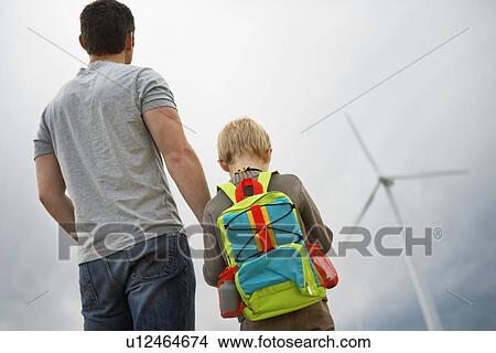 Father and son (7-9) at wind farm View Large Photo Image Picture - Father and son (7-9) at wind farm. Fotosearch