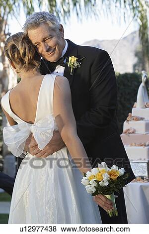 Stock Photo - Father (facing camera) and bride dancing. Fotosearch