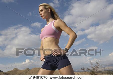 Female jogger with hands on hips, outdoors View Large Photo Image Stock Image - Female jogger with hands on hips, outdoors. Fotosearch