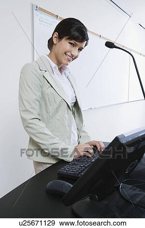 Female lecturer using computer View Large Photo Image Stock Photo - Female lecturer using computer. Fotosearch
