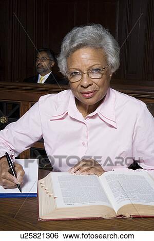 Stock Photograph - Female solicitor working in court, portrait. Fotosearch