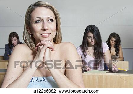 Female student sitting in class View Large Photo Image Stock Image - Female student sitting in class. Fotosearch