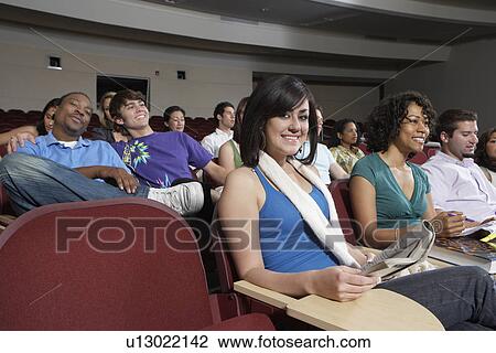 Stock Image - Female student sitting in class, portrait. Fotosearch