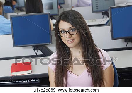Stock Photo - Female student sitting in computer classroom, portrait. Fotosearch