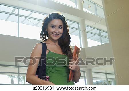 Female student smiling, indoors, portrait View Large Photo Image Stock Image - Female student smiling, indoors, portrait. Fotosearch