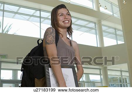 Stock Photo - Female student smiling, indoors. Fotosearch