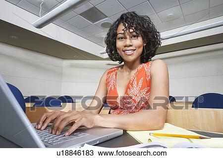 Female student using laptop in lecture theatre, portrait View Large Photo Image Stock Image - Female student using laptop in lecture theatre, portrait. Fotosearch
