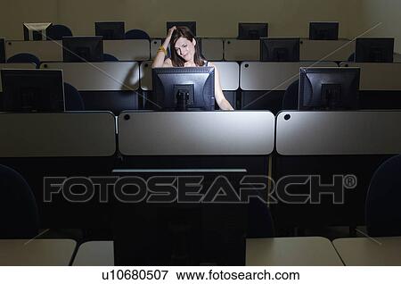 Female student with hand on head in computer classroom View Large Photo Image Stock Photo - Female student with hand on head in computer classroom. Fotosearch