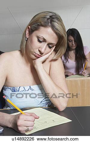 Stock Photograph - Female student working in class. Fotosearch