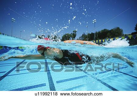 Stock Photo - Female swimmer in pool, surface view. Fotosearch