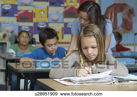 Female Teacher and pupils in classroom View Large Photo Image Stock Photo - Female Teacher and pupils in classroom. Fotosearch