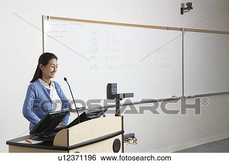 Female teacher in lecture theatre View Large Photo Image Stock Photograph - Female teacher in lecture theatre. Fotosearch