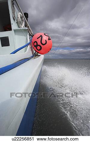 Stock Image - Fishing boat on lake. Fotosearch