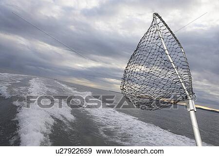 Stock Photo - Fishing net sticking on back of speeding fishing boat. Fotosearch
