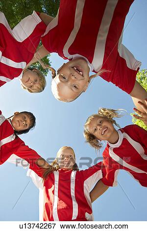 Five children soccer players (7-9 years) huddling, view from below, portrait View Large Photo Image Stock Photo - Five children soccer players (7-9 years) huddling, view from below, portrait. Fotosearch