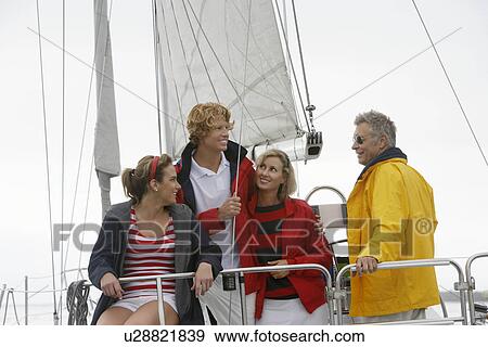 Four people on sailboat in sea View Large Photo Image Stock Photo - Four people on sailboat in sea. Fotosearch