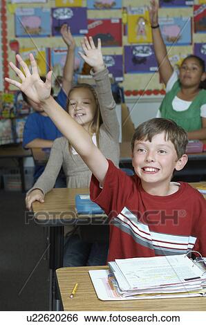 Four pupils with raised hands View Large Photo Image Stock Photograph - Four pupils with raised hands. Fotosearch