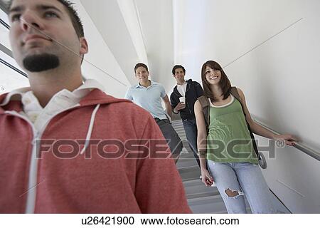 Stock Image - Four students descending stairs. Fotosearch