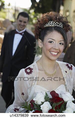 Girl (13-15) with bouquet at Quinceanera, portrait View Large Photo Image Stock Photo - Girl (13-15) with bouquet at Quinceanera, portrait. Fotosearch