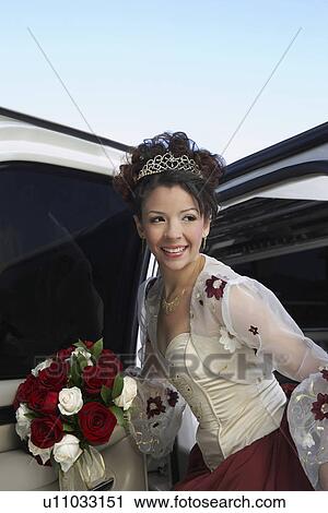 Girl (13-15) with bouquet getting out of limousine at Quinceanera View Large Photo Image Stock Image - Girl (13-15) with bouquet getting out of limousine at Quinceanera. Fotosearch