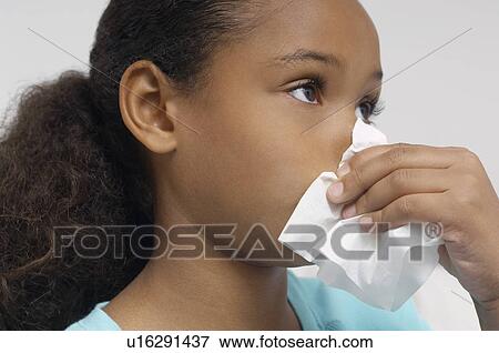 Girl (7-9) blowing nose, close-up View Large Photo Image Stock Photo - Girl (7-9) blowing nose, close-up. Fotosearch