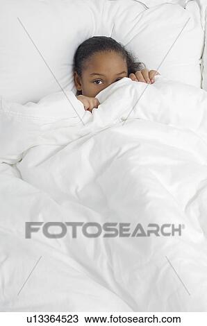 Girl (7-9) hiding under bed covers, portrait View Large Photo Image Stock Image - Girl (7-9) hiding under bed covers, portrait. Fotosearch