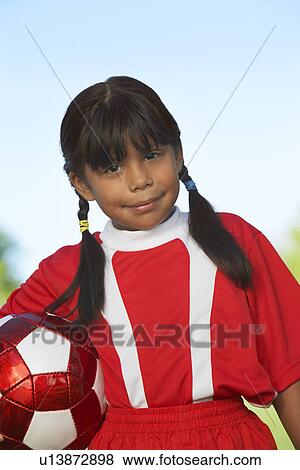 Girl (7-9 years) holding soccer ball under arm, portrait View Large Photo Image Stock Photo - Girl (7-9 years) holding soccer ball under arm, portrait. Fotosearch