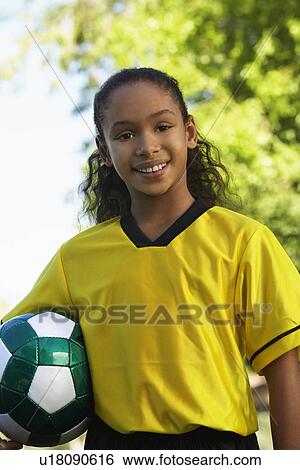 Girl (7-9 years) holding soccer ball under arm, portrait View Large Photo Image Stock Photograph - Girl (7-9 years) holding soccer ball under arm, portrait. Fotosearch