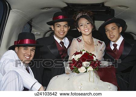 Stock Image - Girl and boys (13-15) in limousine at Quinceanera. Fotosearch