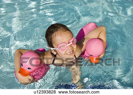 Girl Floating Using Two Pink Rubber Ducks View Large Photo Image Stock Photo - Girl Floating Using Two Pink Rubber Ducks. Fotosearch