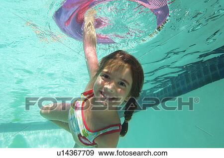 Girl holding inflatable raft underwater in swimming pool, portrait View Large Photo Image Stock Photo - Girl holding inflatable raft underwater in swimming pool, portrait. Fotosearch