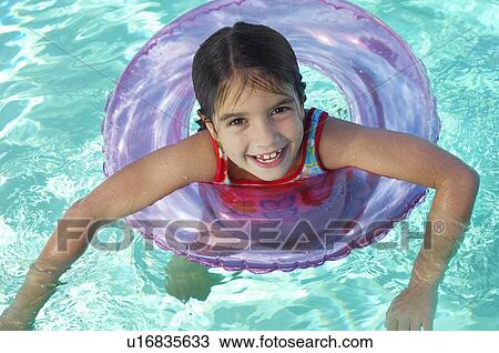 Girl in inflatable raft in swimming pool, portrait View Large Photo Image Stock Image - Girl in inflatable raft in swimming pool, portrait. Fotosearch