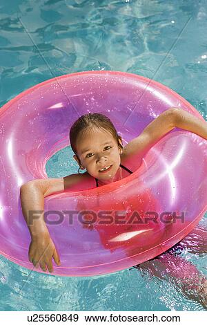 Girl Inside Pink Float Tube in Pool View Large Photo Image Stock Photo - Girl Inside Pink Float Tube in Pool. Fotosearch