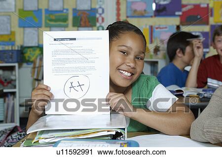 Stock Image - Girl presenting her test result. Fotosearch