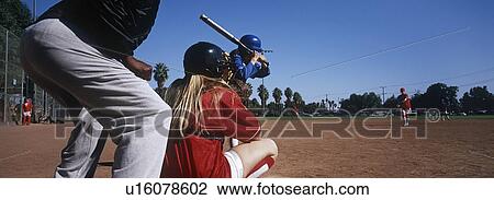 Stock Image - Girls (13-17) playing baseball. Fotosearch