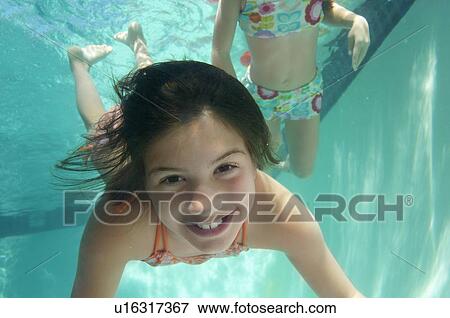 Stock Photo - Girls swimming, underwater view. Fotosearch