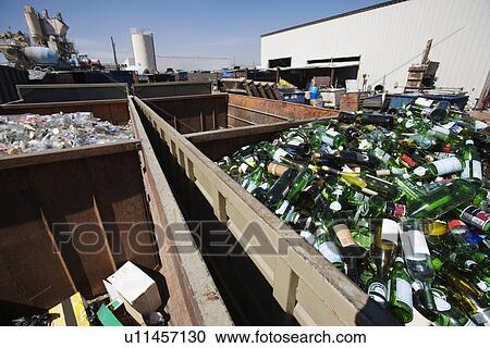 Stock Image - Glass bottles in recycling centre. Fotosearch