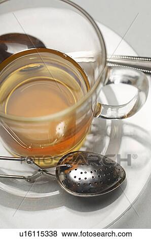 Stock Photo - Glass of tea and strainers, close-up. Fotosearch