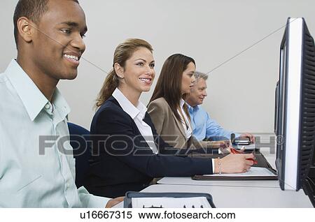 Group of business people using computers in classroom, side view View Large Photo Image Stock Photography - Group of business people using computers in classroom, side view. Fotosearch