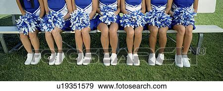 Group of cheerleaders sitting in row on bench, low section View Large Photo Image Stock Photo - Group of cheerleaders sitting in row on bench, low section. Fotosearch