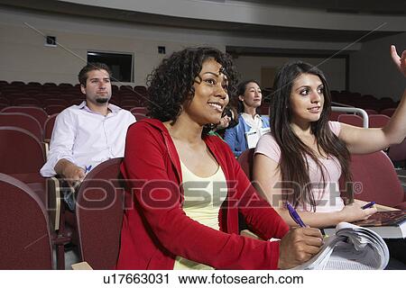 Group of people in classroom, woman in foreground View Large Photo Image Stock Image - Group of people in classroom, woman in foreground. Fotosearch