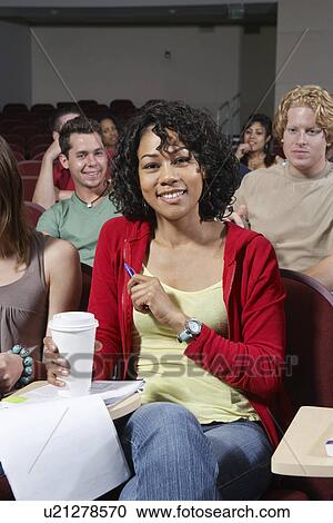 Group of people in classroom, woman in foreground View Large Photo Image Stock Image - Group of people in classroom, woman in foreground. Fotosearch