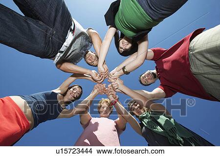 Group of young people in circle, view from below View Large Photo Image Picture - Group of young people in circle, view from below. Fotosearch