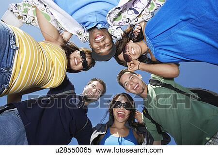 Stock Photography - Group of young people in circle, view from below. Fotosearch