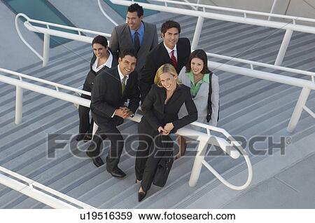 Stock Photo - Group portrait of business people on stairs, elevated view. Fotosearch